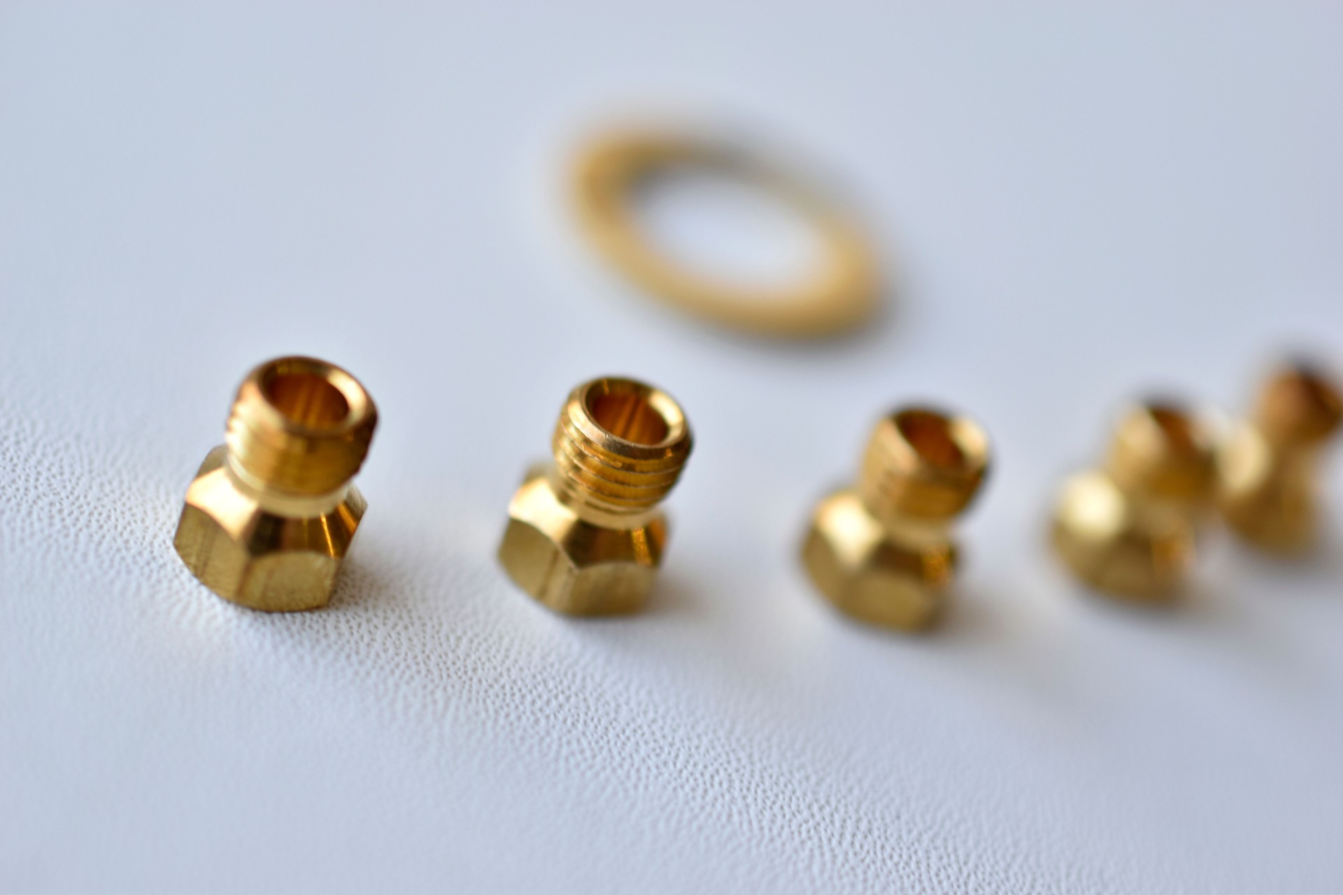 Golden gas burner nozzle bolt on white background